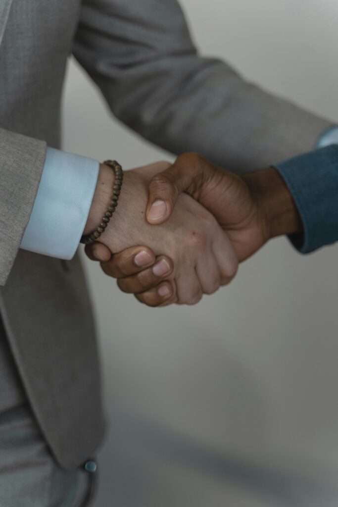 Two business professionals shaking hands, symbolizing agreement and partnership.